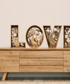 Het Botanisch alfabet dressoir heeft gesneden LOVE letters met florale motieven. Links staat een kleine ronde tafel met potplanten, terwijl rechts een mand staat. De setting is licht en gezellig.